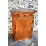 A George III oak hanging corner cupboard having inlay decoration, 96cm high x 74cm wide. This lot