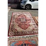 A Persian style rug, having central floral medallion with the central field and borders having