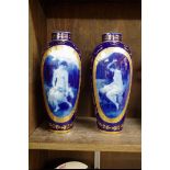 A pair of Vienna porcelain vases, each decorated with a diaphanous maiden against a blue and gilt