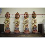 A set of four eastern carved wood polychrome painted figural bird sculptures, 51cm high.