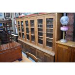 A large modern oak bookcase, 179cm high x 247cm wide