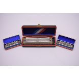 A Hohner 'Super Chromonica' Harmonica, boxed; together with two further Hohner 'Piccolo' harmonicas,