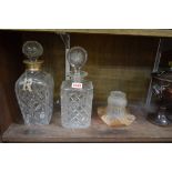 A silver mounted clear glass decanter and stopper; together with another clear glass decanter and