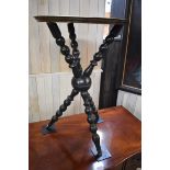 An Eastern brass tray top table, on ebonized bobbin turned tripod 'cat' stand, 34cm diameter.