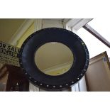 A large modern black framed circular wall mirror, 83cm diameter.