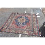 A Persian rug, having central medallion with geometric borders, 172 x 158cm.