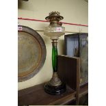 An old brass and coloured glass oil lamp.