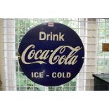 A vintage blue enamel 'Drink Coca-Cola Ice Cold' circular sign, 42.5cm diameter.