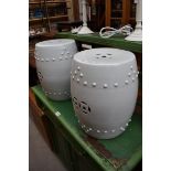 A pair of Chinese blanc de chine barrel form seats, 36cm high.