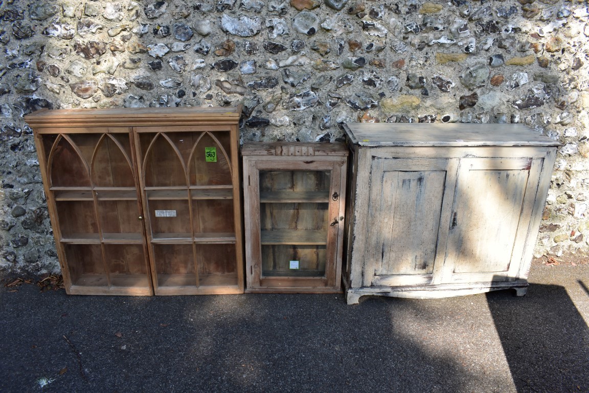 A painted wood two door cupboard, 103cm wide; together with a stripped pine glazed two door cupboard