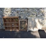 A painted wood two door cupboard, 103cm wide; together with a stripped pine glazed two door cupboard