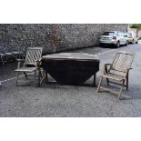 A modern teak two flap garden table and eight teak folding chairs. This lot can only be collected on