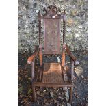 An antique carved walnut and cane folding chair. This lot can only be collected on Saturday 5th