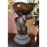 A large old colonial carved teak figural bowl, 61cm high.