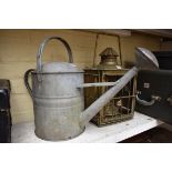 A vintage galvanised watering can, with rose; together with a brass hanging lantern.