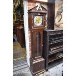An oak reproduction longcase clock, 179cm high, with weights and pendulum.