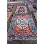 A Persian rug, having central field decorated with geometric design, with floral and geometric