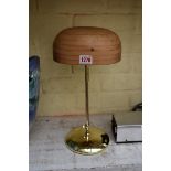 A pine and brass hat stand, adjustable for height.