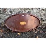 An Edwardian inlaid mahogany oval two handled tray, having inlaid shell decoration to centre, 65cm