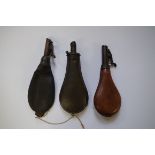 Three 19th century powder flasks.
