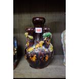 An unusual Chinese brown glazed bulb vase, Kangxi six character mark, applied in relief with