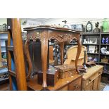 A reproduction carved mahogany concertina action card table, 85cm wide.