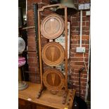 A 1930s walnut and parquetry folding cake stand, 87cm high.