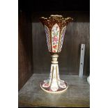 A late 19th century Bohemian ruby glass and overlaid pedestal vase, with painted and cut decoration,