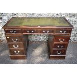 A reproduction mahogany veneered kneehole desk, having green leather inset top, 123cm wide. This lot