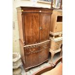 A reproduction mahogany and crossbanded serpentine fronted side cabinet, 72cm wide.