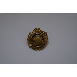 A Swedish gilt metal and blue enamel military badge, stamped 'C C Sporrong & Co, Stockholm', 4cm