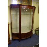 An Edwardian mahogany and line inlaid serpentine fronted display cabinet, 189.5 high x 156cm wide.