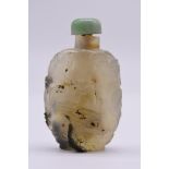 A Chinese carved agate snuff bottle, 18th/19th century, decorated in relief with figures in a