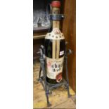 A large old bottle of Asbach Uralt brandy, in pewter cradle, the bottle 50.5cm high.