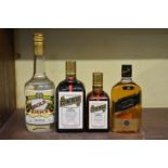 A mixed lot of spirits, comprising: a 70cl bottle of Cointreau; a similar 35cl bottle; a 50cl