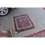 A small square rug, having diamond to central field, with floral borders, 82 x 90cm.