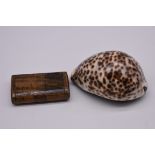 An antique wood snuff box; together with another cowrie shell example.