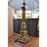 A gilt metal table lamp, height excluding fitting 57cm.