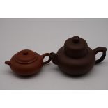 Two Chinese yixing teapots and covers, seal mark to base of each, largest 8cm high.