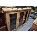 A Victorian pine breakfront bookcase, 183cm wide, (one glass panel lacking).