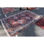 A Persian rug, having cross decoration to central field, with floral and geometric borders, 242 x