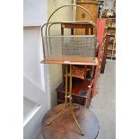 An old brass and mahogany tripod magazine stand, 88cm high.