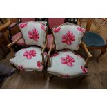 A pair of beechwood and upholstered fauteuils.