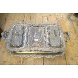 An impressive electroplated twin handled serving tray, with two covers, 73.5cm wide; together with