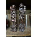 A pair of Chinese carved hardwood and metal wire inlaid figures, 36cm high.