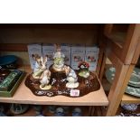 Five Royal Albert 'Bunnykins' figures, each boxed, on stand.