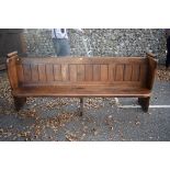An old pine church pew, 214cm long, (alterations).This lot can only be collected on Saturday 10th