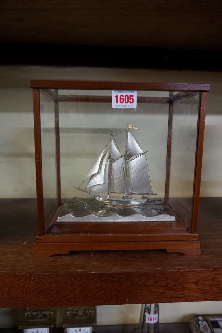 A Japanese silver and silver plated model yacht, by Seki, in glass case, the case 23cm high x 23cm