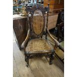 A good Charles II style carved walnut and cane open armchair.