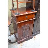 A carved hardwood bedside cupboard, 45cm wide.